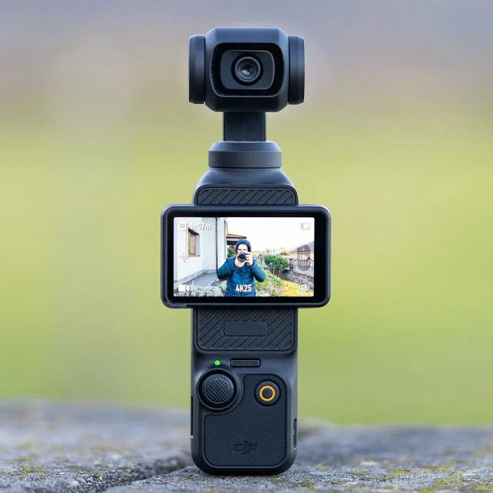Handheld gimbal camera with screen displaying vlogger recording outdoors